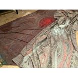 A 19th century woollen Paisley shawl, the central crimson reserve against a ground in greens,
