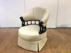 A late 19th century ebonised revolving chair, with harp-shaped back and circular seat above a