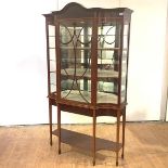 An Edwardian mahogany and boxwood-lined breakfront display cabinet, the central astragal door with