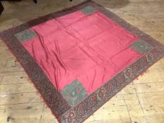 An unusual 19th century woollen Paisley shawl, worked with a large cherry red central panel, the