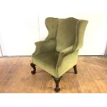 A late 19th/early 20th century mahogany wing armchair, of George II style, with cream velvet