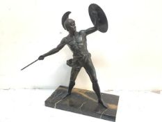 A bronzed metal figure of a Greek warrior, early 20th century, modelled with shield on upraised left