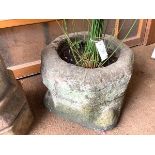 A carved sandstone planter, probably originally a font, of circular form. 36cm by 46cm