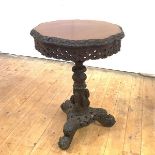 A Burmese rosewood occasional table, with foliate border and frieze on a complimentary shaft and