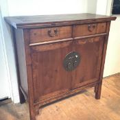 A Chinese elm cabinet, first half of the 20th century, with exposed tenons and bronze mounts. 106.