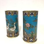 A striking pair of Japanese cloisonne enamel vases, c. 1900, of cylindrical form, one decorated with
