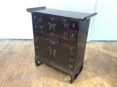 A Chinese elm and simulated elm table cabinet, the pagoda top above brass butterfly hinges and