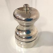 A large silver pepper mill, Douglas Pell, London 1990, of capstan form. Height 10.5cm