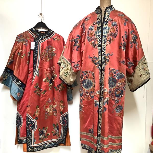 Two Chinese embroidered silk robes, probably c. 1900: the first with "mandarin" collar, of coat