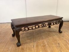 A Chinese hardwood low table, probably late 19th century, the rectangular top above a pierced