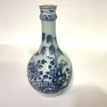 A Chinese blue and white porcelain vase, of bottle form, with ringed neck, painted with a willow