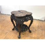 A late 19th century Burmese carved hardwood jardiniere stand, the lobed marble-inset top and