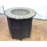 A fine Indian tray top centre table, Jaipur, the engraved brass tray with dished centre and all-over