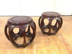 A pair of Chinese hardwood verandah stools, with dished seats. 34cm by 36cm diameter