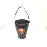 A leather fire bucket in 19th century style, of characteristic form, in black and applied with a red