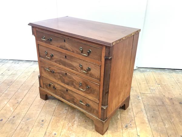 A 19th century mahogany chest in the George III style, of small proportions, the four long drawers