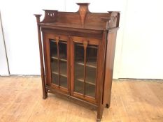 A Glasgow School walnut and inlaid cabinet bookcase, c. 1900, the gallery back incorporating a