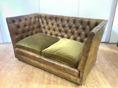 A buttoned leather Knole-style sofa, with loose fabric seat cushions, the frame with close nail