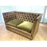 A buttoned leather Knole-style sofa, with loose fabric seat cushions, the frame with close nail