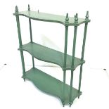 A set of green-painted hanging shelves, modern, each of serpentine outline with turned column