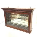 An Edwardian walnut hanging chemist's cabinet, with dentil cornice, the door enclosing a mirror back