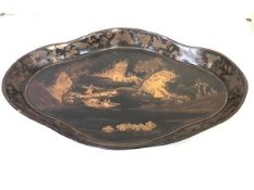 A large Chinoiserie gilt-decorated papier mache galleried tray, of shaped lozenge form, the well