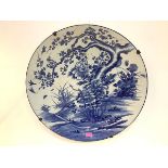 A very large Japanese blue and white porcelain charger, Meiji period, painted with birds around a