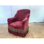 A 19th century mahogany framed tub chair, c. 1880, with red velvet upholstery and tasselled fringe