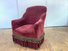 A 19th century mahogany framed tub chair, c. 1880, with red velvet upholstery and tasselled fringe