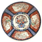 A large Japanese Imari porcelain charger, c. 1900, the well painted with a vase of flowers, the