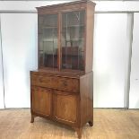 A Regency mahogany secretaire bookcase, c. 1810, with arched astragal glazed doors and fitted fall-