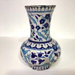 A Persian pottery vase, late 19th century, of baluster form with flared neck, decorated in blue