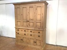 A pine 19th century style housekeeper's cupboard, the projecting cornice above a pair of hinged