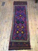 An old Suzani kelim runner, the central field with multiple diamonds in vibrant colours, within a