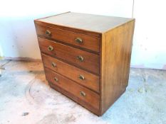 An Edwardian mahogany chest of drawers with raised moulded edge to top, above four graduated