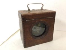 An early 20thc pigeon racing timer in wooden case, handle to top with stamp Belgica (19cm x 12cm x