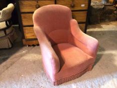 A bedroom tub chair in mauve upholstery with tassel fringed apron (76cm x 65cm x 66cm)