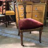 A late Victorian oak side chair, with rosette to crest rail above a stylised column splat with