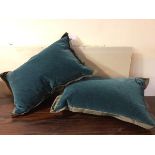 A pair of Donghia cushions, in teal fabric with extended edges (each: 34cm x 56cm)