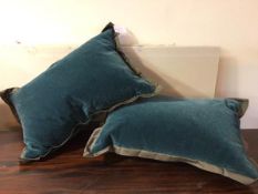 A pair of Donghia cushions, in teal fabric with extended edges (each: 34cm x 56cm)