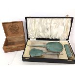 A 1930s/40s vanity set with hand mirror, hair brush and clothes brush, all with guilloche backs,