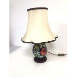 A Moorcroft table lamp of baluster form with poppy pattern on circular base, complete with shade (