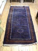A North West Persian rug, the indigo field with a repeating radiating diamond pattern within