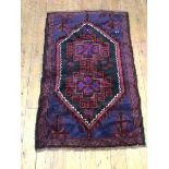 An old Baluchi rug, the central medallion with geometric and foliate decoration, the medallion and
