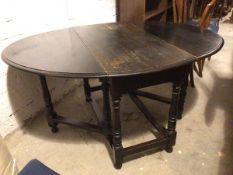 An early 20thc ebonised gateleg table with oval top on turned supports united by stretchers, on pear