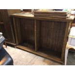 An oak open bookcase, the moulded top above two shelf spaces each with two adjustable shelves (105cm