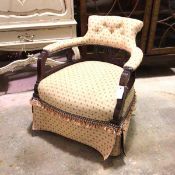 A Victorian stained pine armchair with later upholstery, with repeating stylised flowerhead