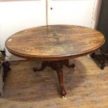 A 19thc walnut loo table, with boxwood and ebony inlay, on tripod base terminating in castors (