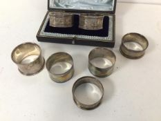 A collection of silver napkin rings including a pair of Edwardian Sheffield silver octagonal