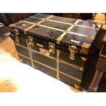 A vintage style travelling trunk with gilt metal mounts and four latches to front, lacking key (63cm